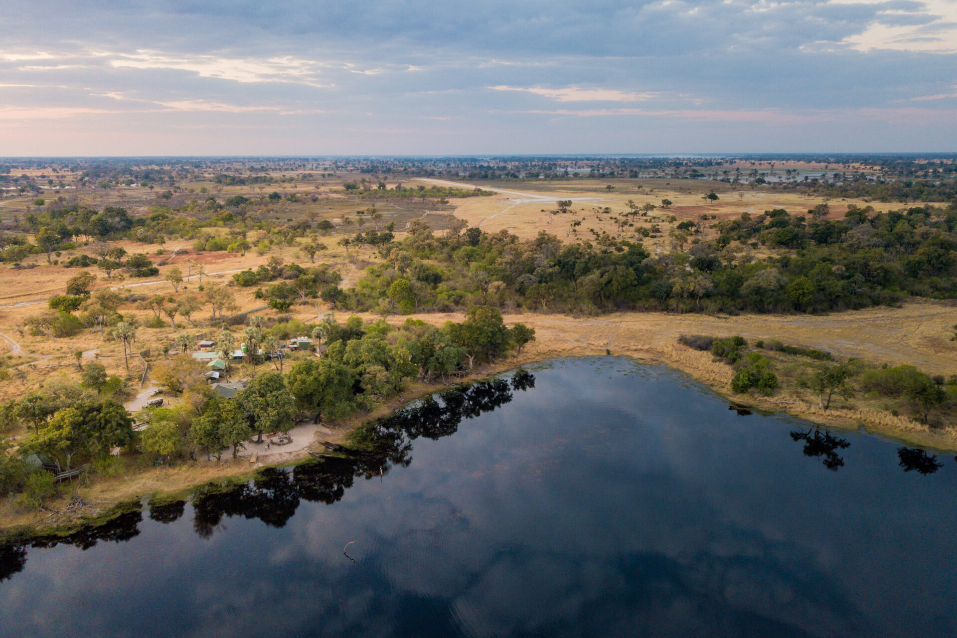 Aerial view of Pom Pom Camp beside a lagoon in the Okavango Delta.