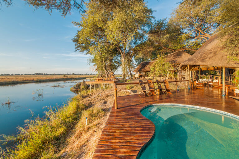 Pool and wooden deck overlooking river and grasslands at Lagoon Camp.