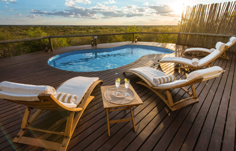 Reclining chairs and swimming pool overlooking the Kalahari at Tau Pan Camp.