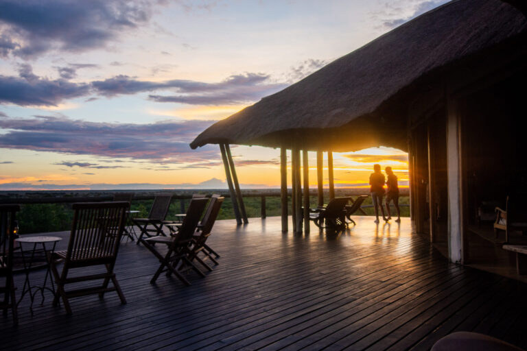 Guests enjoying sunset on the viewing deck at Tau Pan Camp.
