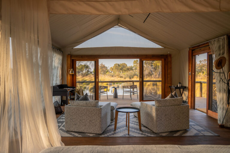 View from bed toward private deck overlooking the Okavango Delta at Four Rivers Camp.