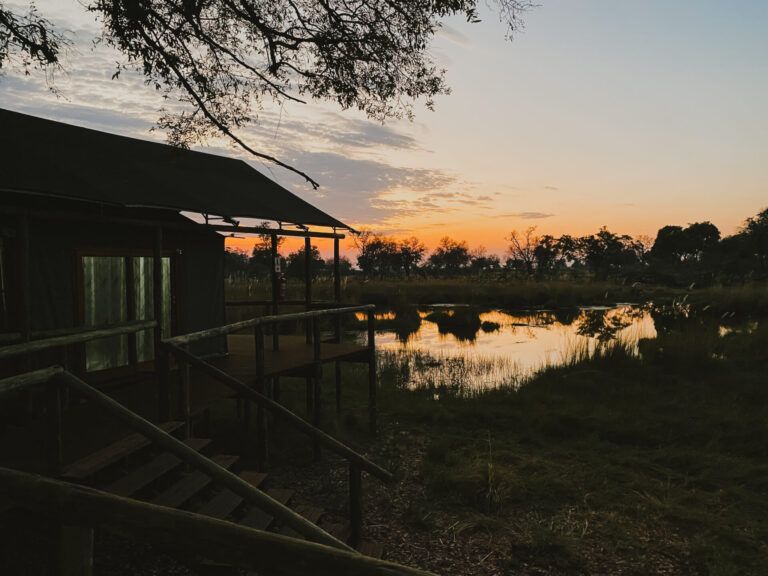 Tent veranda overlooking a lagoon at sunrise at Four Rivers Camp.