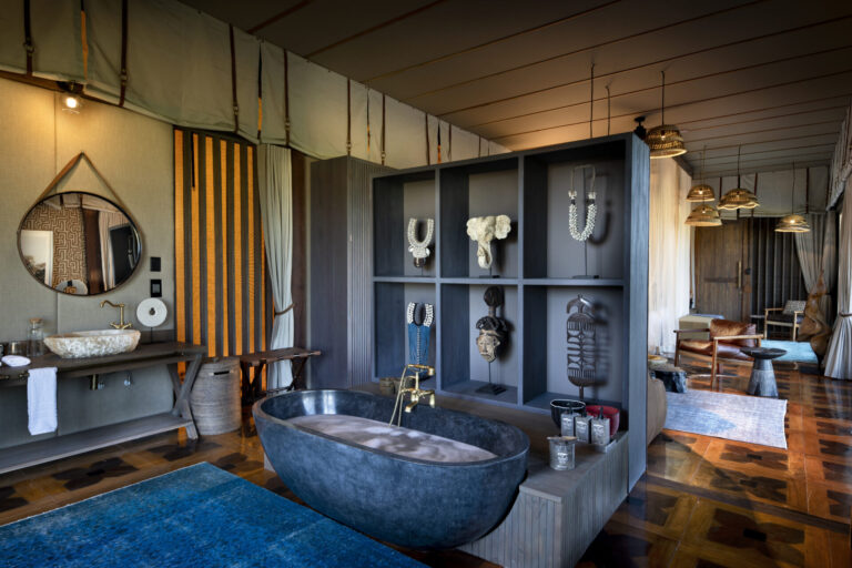 Atzaró Okavango Camp luxury bathroom with freestanding stone bathtub and modern African décor in Botswana