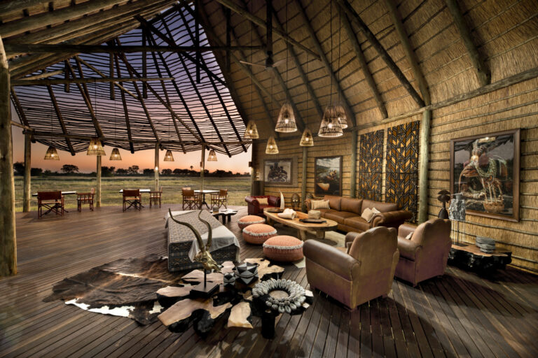 Main lounge with thatched roof and luxury seating at Atzaró Okavango Camp in Botswana.
