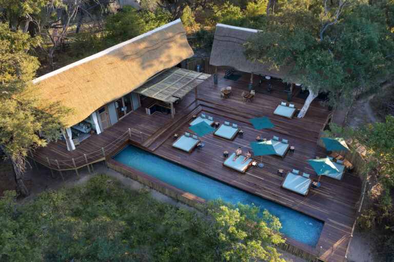 Atzaró Okavango Camp swimming pool and sun loungers on wooden deck in Botswana.