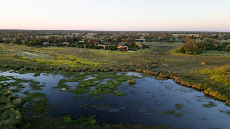Aerial view of Atzaró Okavango Camp surrounded by floodplains in Botswana.
